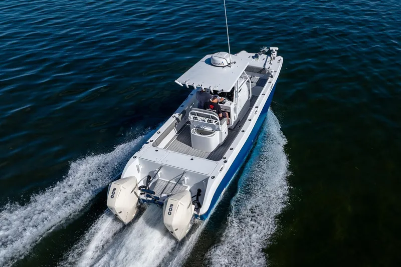 Slide: The Image of Aerial view of 1998 World Cat 266 SF boat cruising on open water. - 15