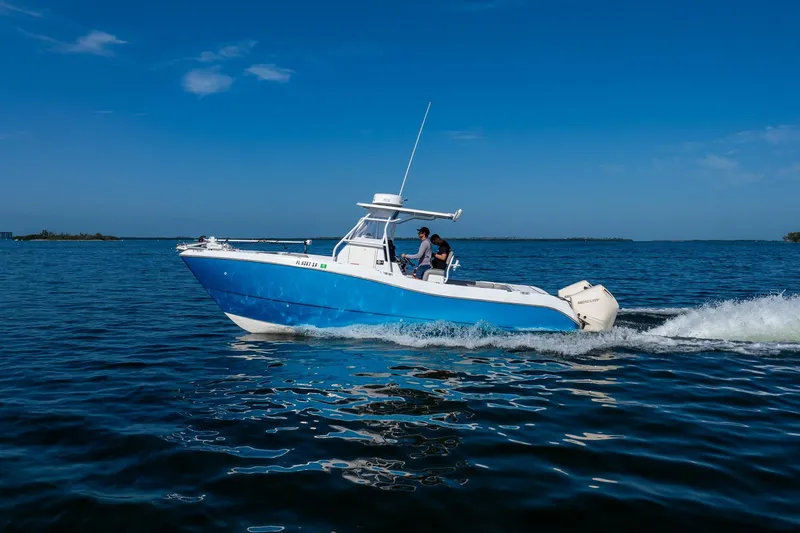 Slide: The Image of 1998 World Cat 266 SF boat cruising on open water under clear blue skies. - 19