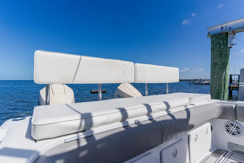 Slide: The Image of 1998 World Cat 266 SF boat interior with cushioned seating, overlooking calm blue waters. - 23