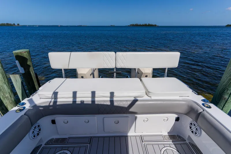 Slide: The Image of 1998 World Cat 266 SF boat interior with cushioned seating, overlooking serene blue waters. - 25