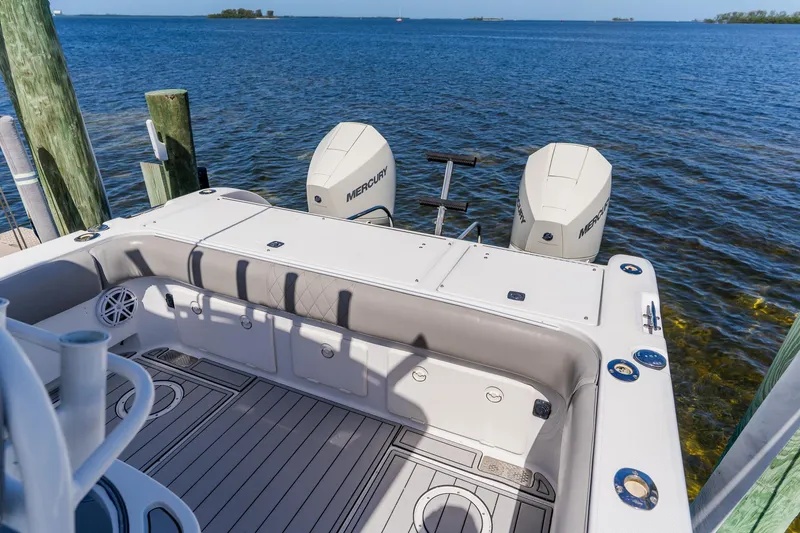 Slide: The Image of 1998 World Cat 266 SF boat with dual Mercury engines docked by the water. - 27