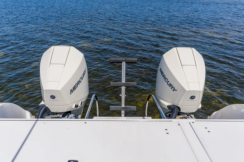 Slide: The Image of Twin Mercury outboard engines on a 1998 World Cat 266 SF boat, viewed from the stern. - 28