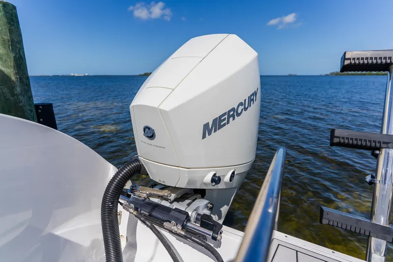Slide: The Image of Mercury outboard motor on a 1998 World Cat 266 SF boat, ocean view background. - 29