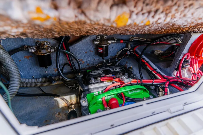 Slide: The Image of Battery compartment of a 1998 World Cat 266 SF boat with wiring and components. - 34