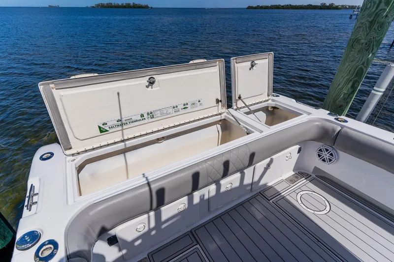 Slide: The Image of Open storage compartments on a 1998 World Cat 266 SF boat, overlooking serene blue waters. - 37