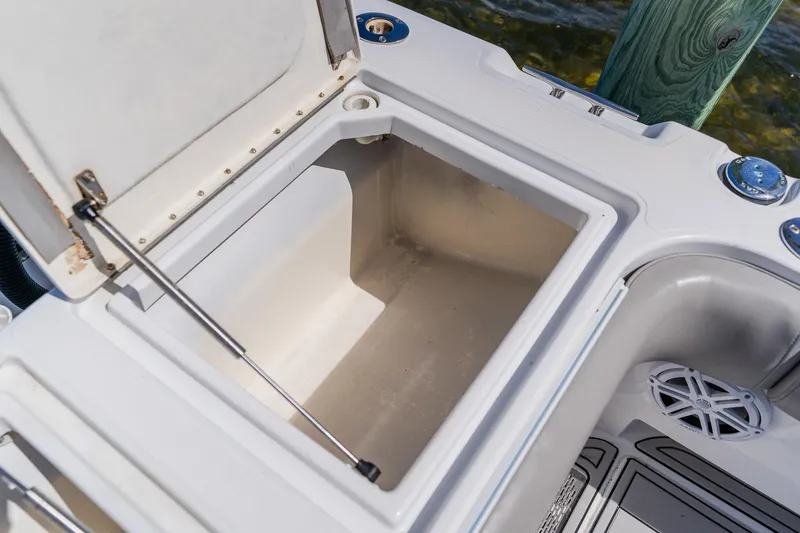 Slide: The Image of Open storage compartment on a 1998 World Cat 266 SF boat, near water. - 39