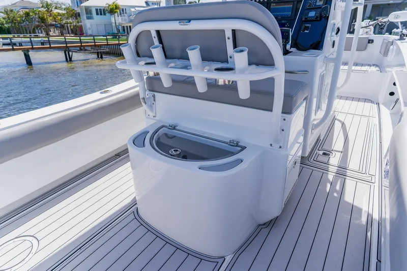 Slide: The Image of 1998 World Cat 266 SF boat interior with seating, rod holders, and open storage compartment. - 44