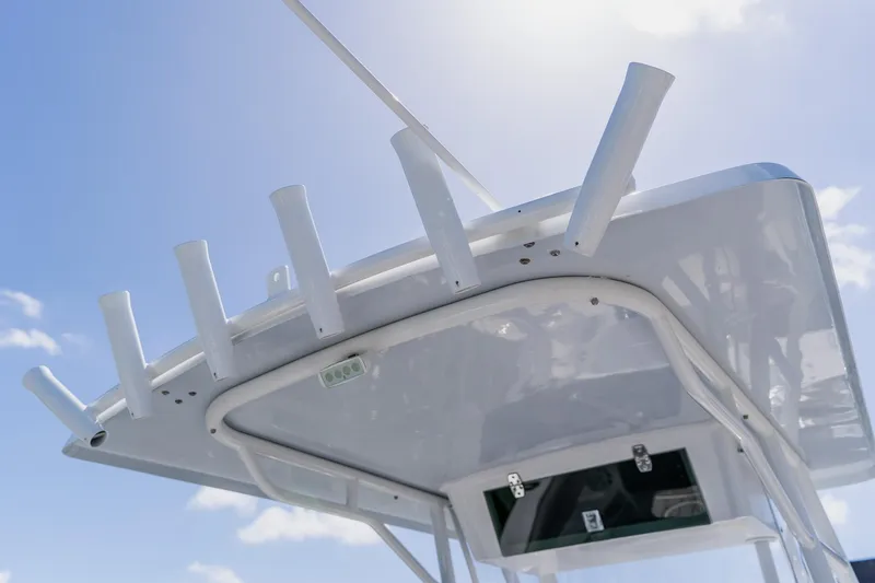 Slide: The Image of T-top of 1998 World Cat 266 SF boat with rod holders against blue sky. - 48