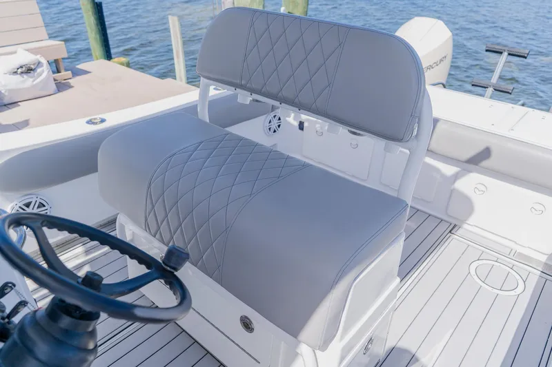 Slide: The Image of 1998 World Cat 266 SF boat interior with gray cushioned seating and steering wheel. - 51