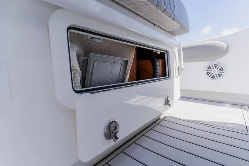 Slide: The Image of Storage compartment on a 1998 World Cat 266 SF boat, featuring sleek white interior design. - 54