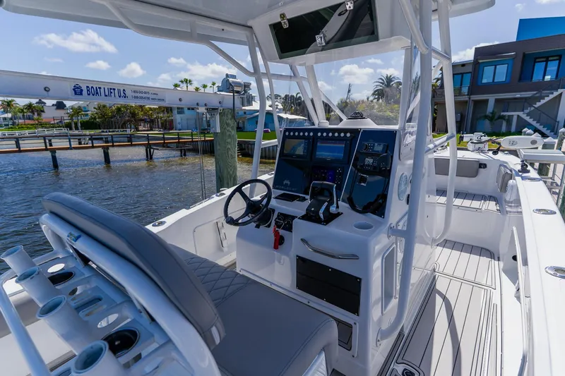 Slide: The Image of 1998 World Cat 266 SF boat interior with modern controls and waterfront view. - 55