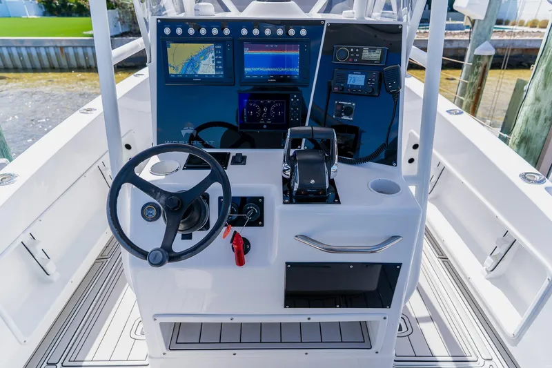 Slide: The Image of Steering console of a 1998 World Cat 266 SF boat with navigation equipment. - 56