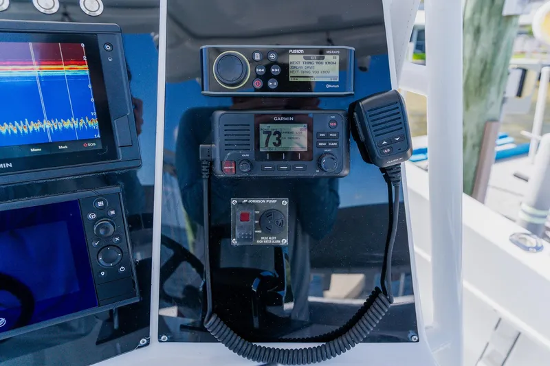 Slide: The Image of Control panel of a 1998 World Cat 266 SF boat with navigation and communication equipment. - 59