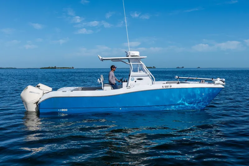 Slide: The Image of 1998 World Cat 266 SF boat on calm blue ocean with clear sky background. - 6