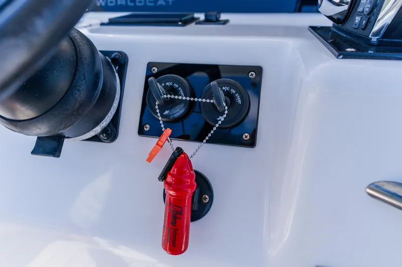 Slide: The Image of Control panel of a 1998 World Cat 266 SF boat with ignition switches and safety lanyard. - 61