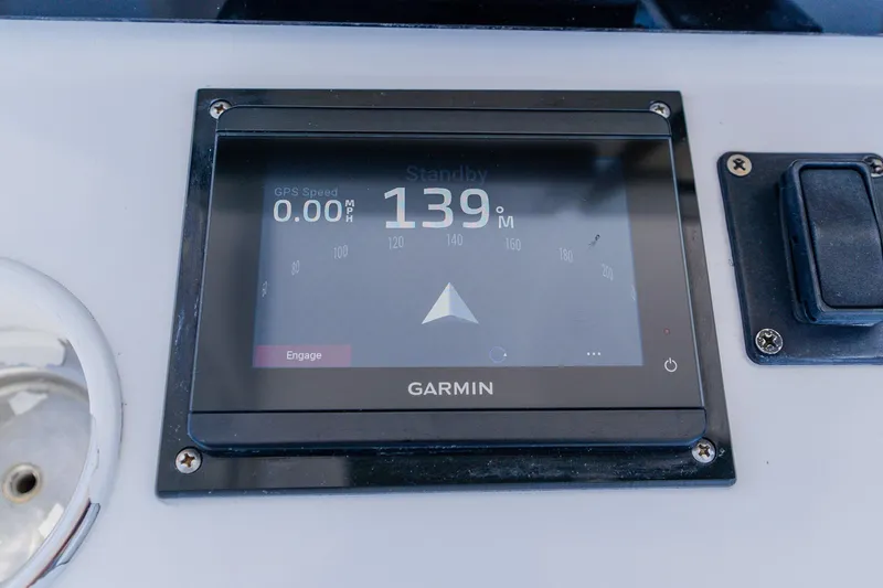 Slide: The Image of Garmin GPS display on 1998 World Cat 266 SF boat dashboard, showing speed and heading. - 62