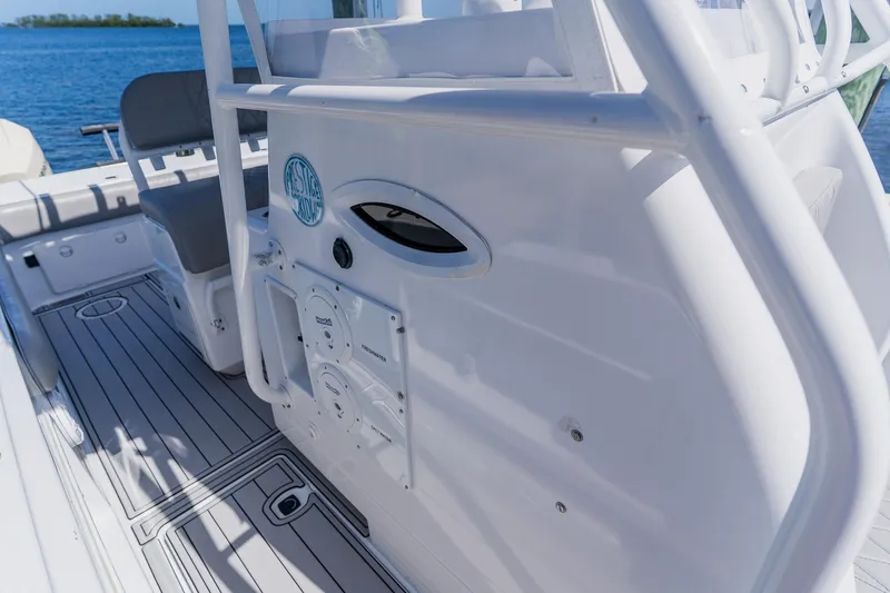 Slide: The Image of 1998 World Cat 266 SF boat interior with seating and control panel, docked by the water. - 65
