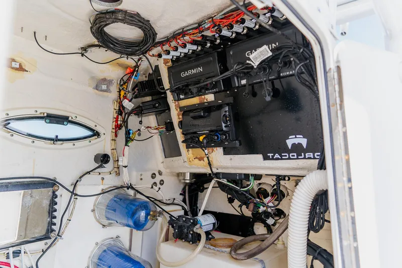 Slide: The Image of Interior view of a 1998 World Cat 266 SF boat's electronic wiring and equipment setup. - 69
