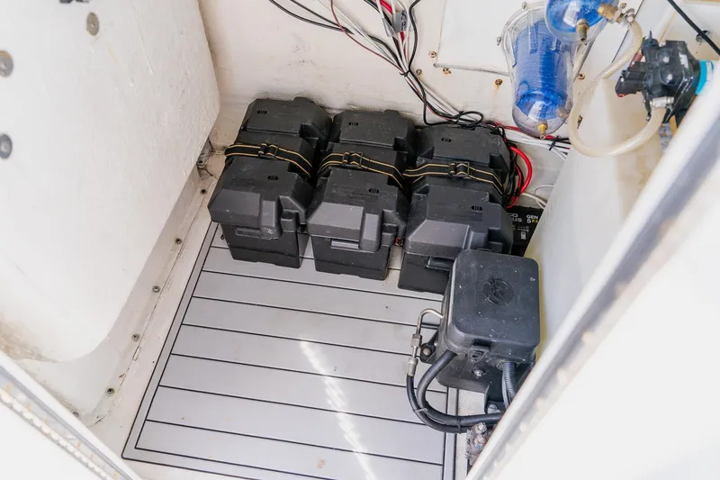 Slide: The Image of Battery compartment of a 1998 World Cat 266 SF boat, featuring multiple secured batteries. - 71