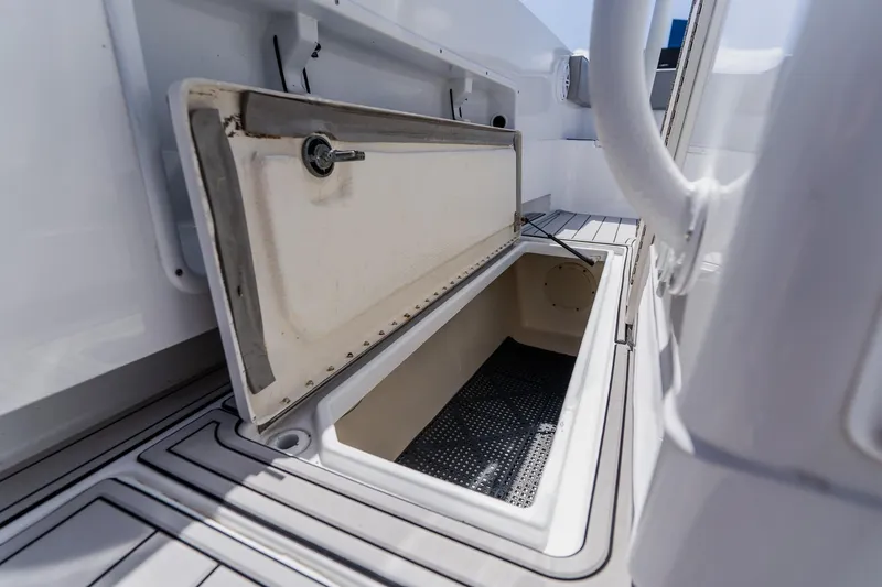 Slide: The Image of Open storage compartment on a 1998 World Cat 266 SF boat deck. - 74