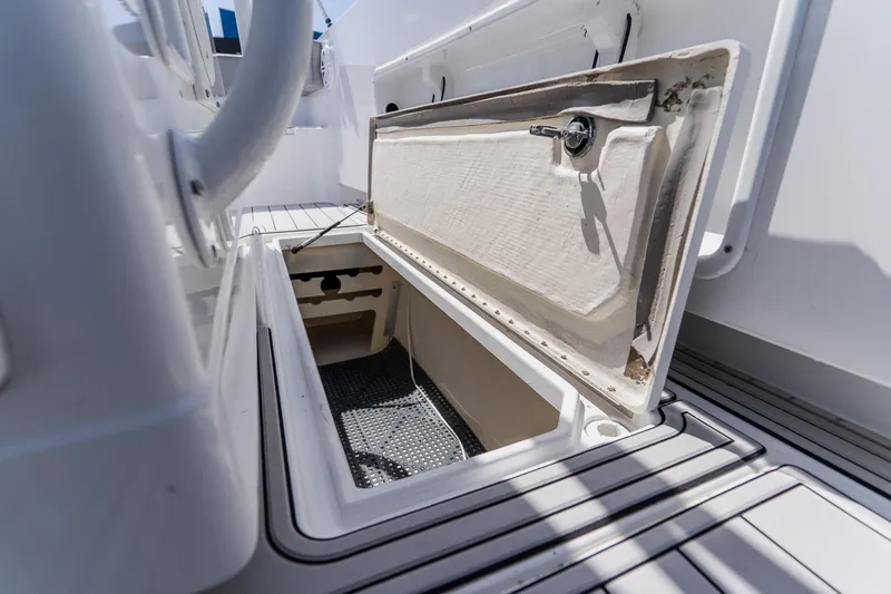 Slide: The Image of Open storage compartment on 1998 World Cat 266 SF boat deck. - 75