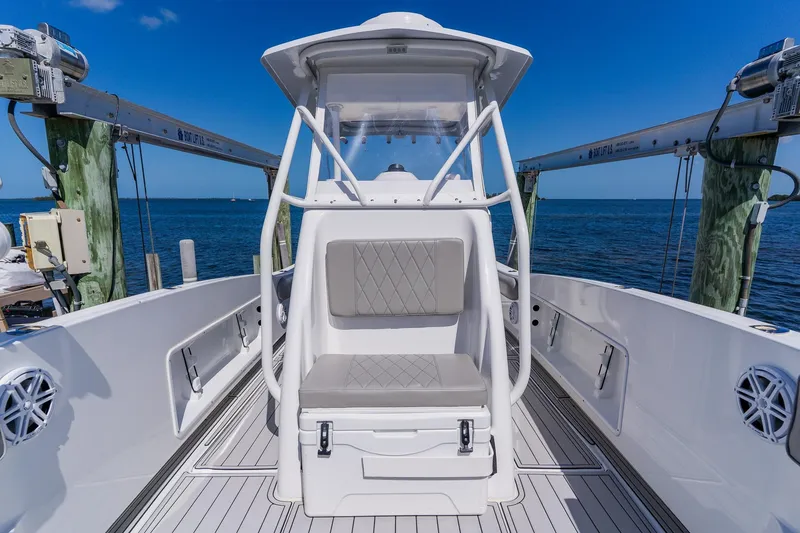 Slide: The Image of 1998 World Cat 266 SF boat interior with seating, docked by the ocean. - 76