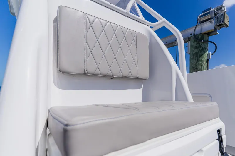 Slide: The Image of 1998 World Cat 266 SF boat seat with diamond-stitched upholstery against a clear blue sky. - 77