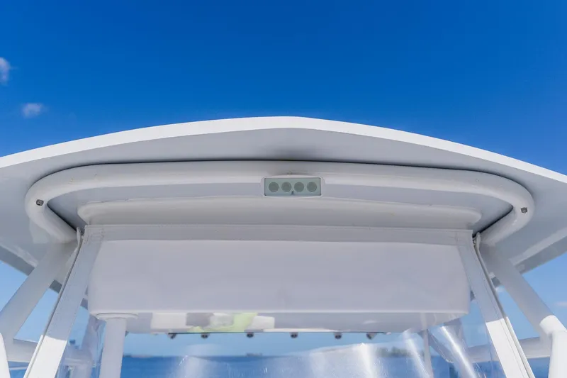 Slide: The Image of 1998 World Cat 266 SF boat canopy against clear blue sky. - 78