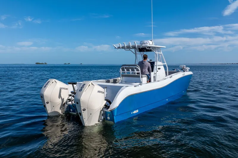 Slide: The Image of Blue 1998 World Cat 266 SF boat with dual Mercury engines on open water. - 8