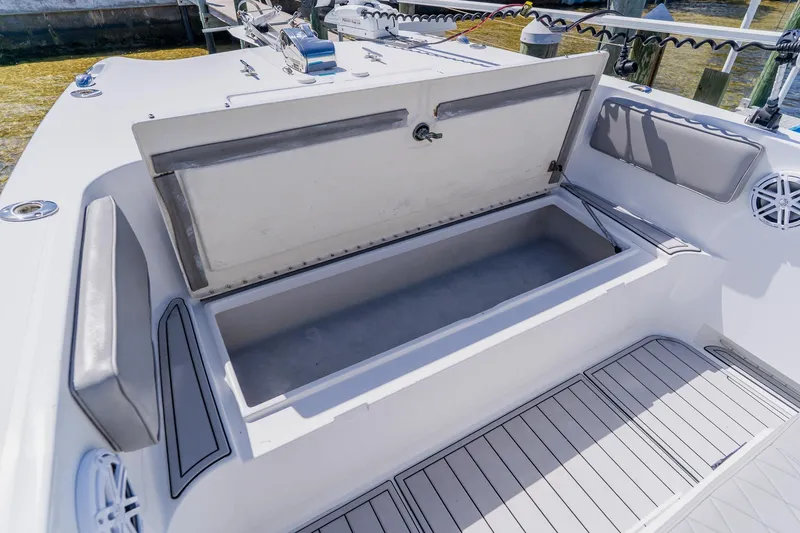 Slide: The Image of Open storage compartment on a 1998 World Cat 266 SF boat deck. - 86