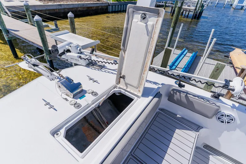 Slide: The Image of 1998 World Cat 266 SF boat deck with open storage compartment and fishing equipment. - 89