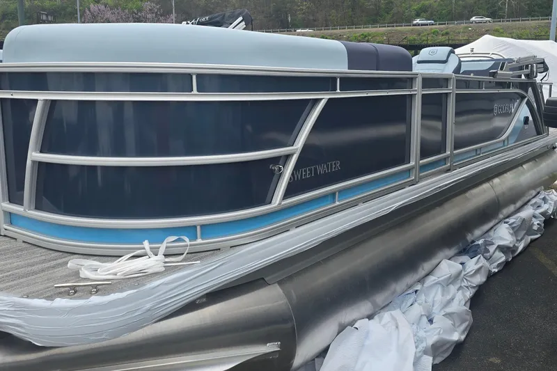 The Image of 2026 Godfrey Sweetwater 2286 SFL pontoon boat, sleek design, docked outdoors. - 0