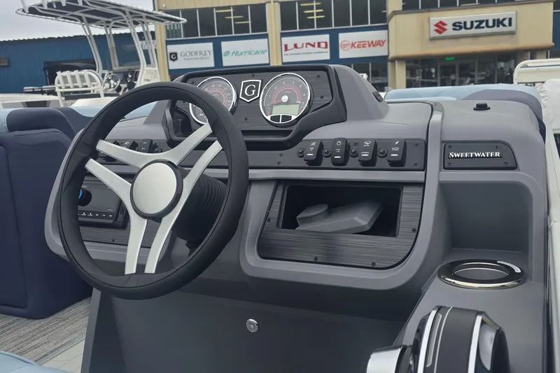 Slide: The Image of Steering console of 2026 Godfrey Sweetwater 2286 SFL boat with dashboard controls. - 4