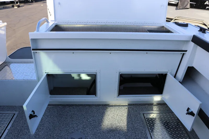 Slide: The Image of 2026 Alumaweld Horizon 26 boat storage compartments with open doors on deck. - 20
