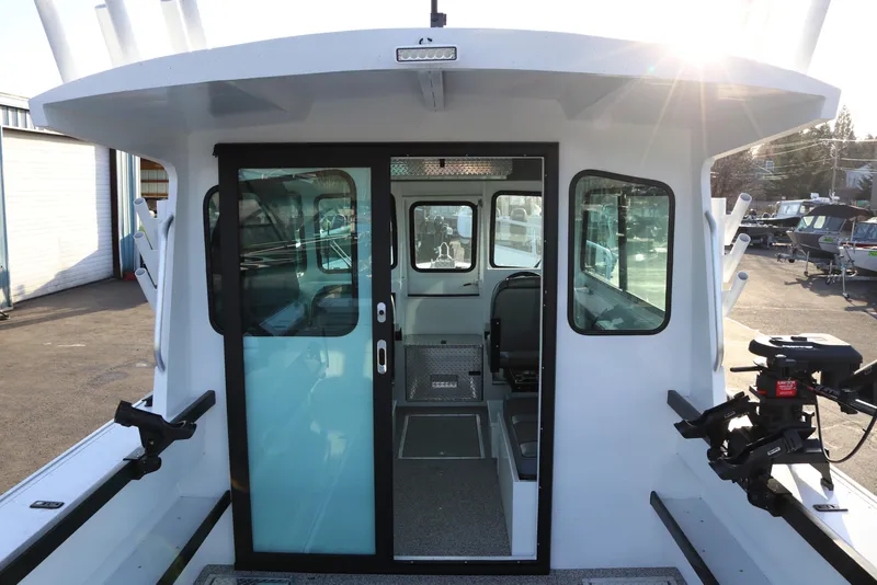 Slide: The Image of 2026 Alumaweld Horizon 26 boat interior with sliding glass door and seating. - 4