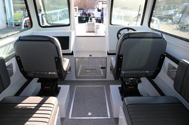 Slide: The Image of Interior of 2026 Alumaweld Horizon 26 boat with modern seating and steering wheel. - 5