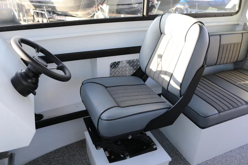 Slide: The Image of Interior of 2026 Alumaweld Horizon 26 boat with steering wheel and seating. - 6