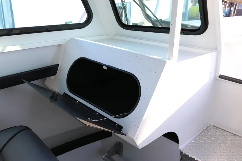 Slide: The Image of Interior of 2026 Alumaweld Horizon 26 boat showing storage compartment and seating. - 9