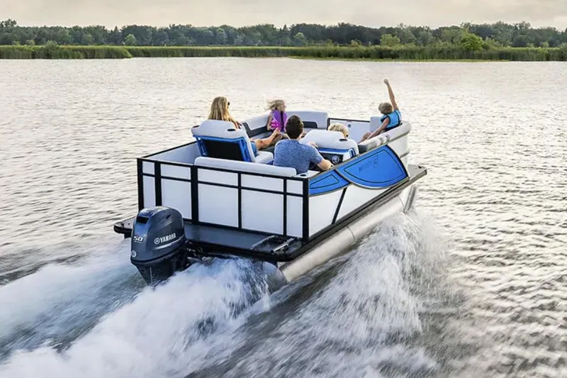 Slide: The Image of Manufacturer Provided Image: 2026 Godfrey Mighty G 1476 C pontoon boat cruising on a serene lake with passengers. - 5