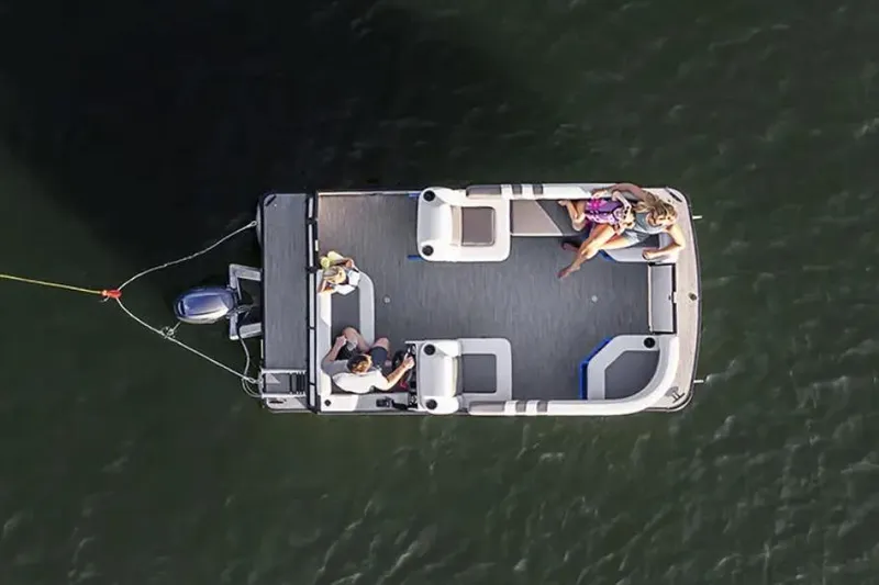 Slide: The Image of Manufacturer Provided Image: 2026 Godfrey Mighty G 1476 C pontoon boat cruising on water with two passengers. - 6