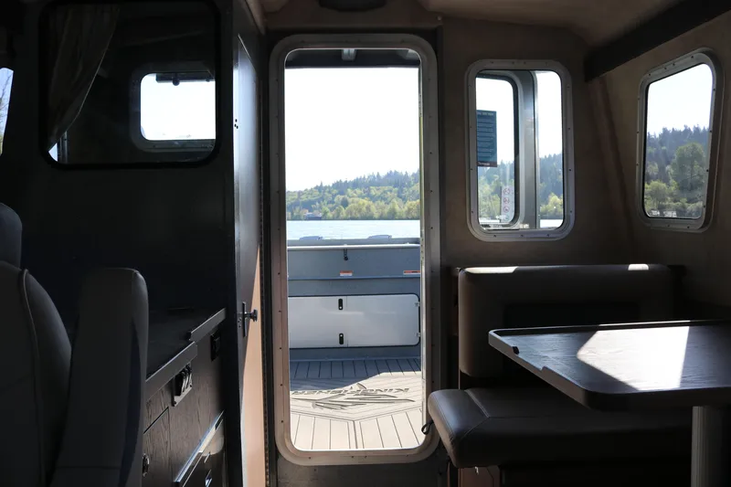 Slide: The Image of Interior view of 2026 KingFisher 3025 XRS boat with scenic lake backdrop. - 14