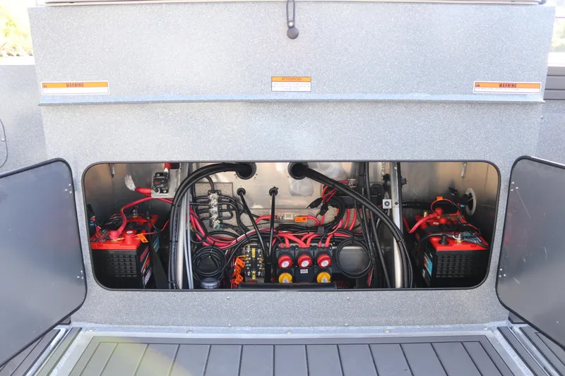 Slide: The Image of Engine compartment of 2026 KingFisher 3025 XRS boat, showcasing wiring and battery setup. - 18