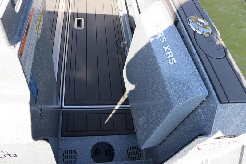Slide: The Image of 2026 KingFisher 3025 XRS boat deck with storage compartment and sleek design. - 19