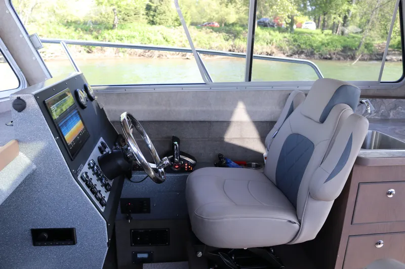 Slide: The Image of Interior of 2026 KingFisher 3025 XRS boat with modern helm and comfortable seating. - 7