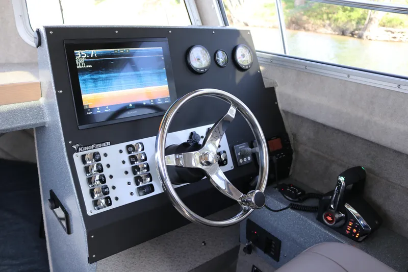 Slide: The Image of Helm of 2026 KingFisher 3025 XRS boat with modern controls and navigation display. - 8