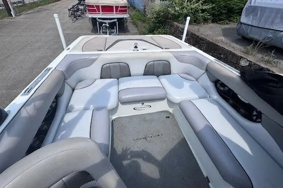 Slide: The Image of 2009 Centurion Avalanche C4 boat interior with gray and white seating, parked outdoors. - 4