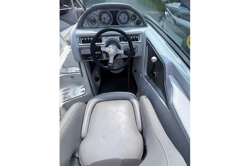 Slide: The Image of 2009 Centurion Avalanche C4 boat cockpit with steering wheel and dashboard controls. - 7