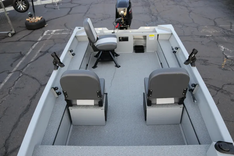Slide: The Image of 2026 Smoker Craft Sportsman 1660 boat interior with two seats and fishing rod holders. - 11