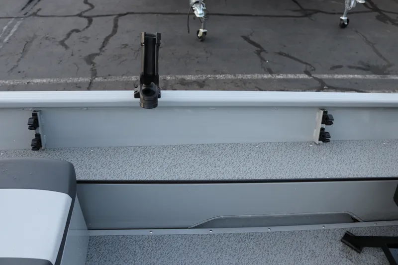 Slide: The Image of 2026 Smoker Craft Sportsman 1660 boat interior with rod holder and seating. - 16