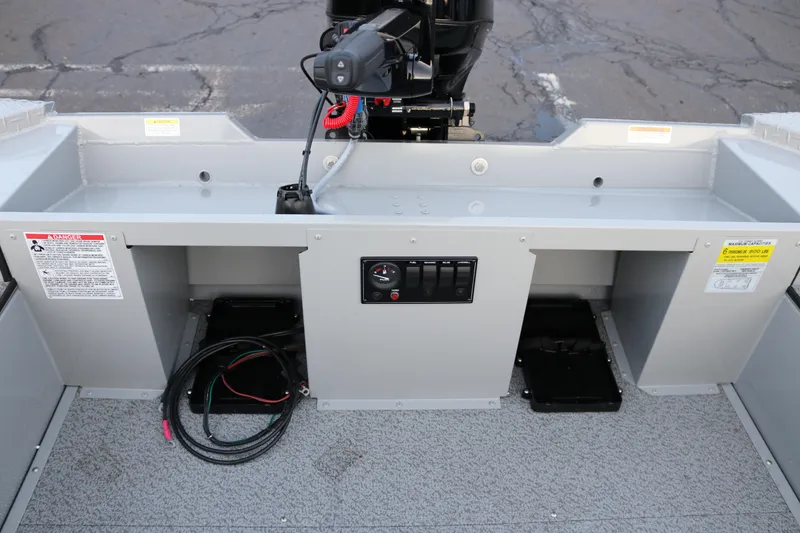 Slide: The Image of 2026 Smoker Craft Sportsman 1660 boat interior with motor and control panel. - 17